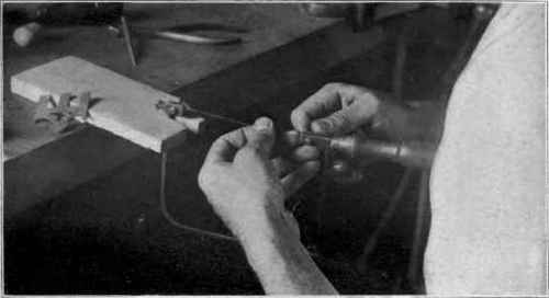 Fig . 29. Placing new blade in saw frame.