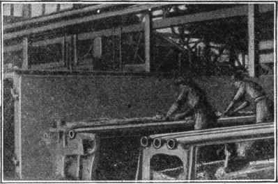 Fig. 189. Making Cores for Cast Iron Pipe. Cores for pipes are made on a bar. Hay is wound on this bar and then loam is carefully worked into the hay. The core is then dried and given a second coat of mud, dried again, and blackened. It is then placed in the mold.