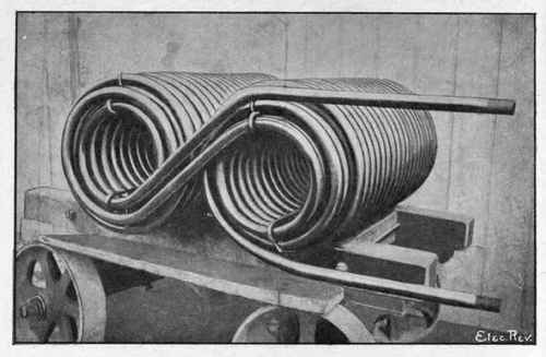 Fig. 54. Pipe Coil for Refrigerating Machine, Electrically Welded by Thomson Process. Pipes Welded end to end by moving Welding Machine during Operation of Coiling.