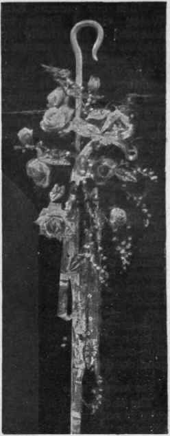 Bridesmaid's crook of white enamel trimmed pink roses, lilies of the valley choice argrite foliage, tied with silver