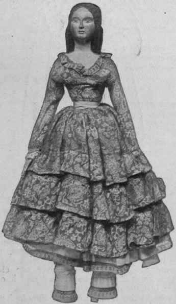 Doll of the crinoline period: carved wood hands and body head and hair of composition moulded in one.