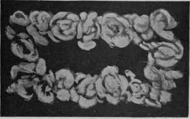 White rose slide for confining the satin folds on a debutante's dance dress