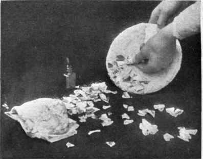 After a smooth layer of putty has been applied to the surface of the article, pieces of pretty china, broken very small, are embedded in the putty, according to the worker's taste