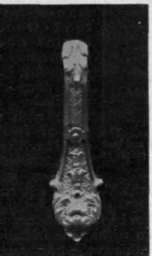 An elaborately wrought knocker in the French style