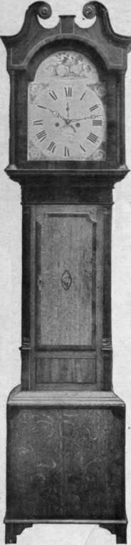 Fig. 3. Oak and mahogany grandfather clock. The four corners outside the dial are engraved with a floral design, and a study of fruit fills the arched top Hampton & Son