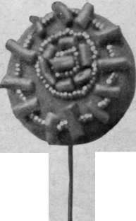 Red coral in short bars interspersed with tiny steel beads and arranged in circles gives a charming effect