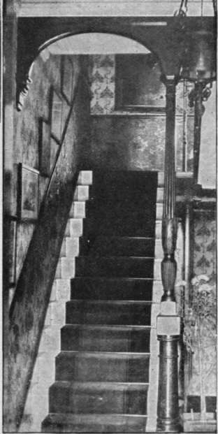 A carved Chippendale bedpost utilised as a pillar to support an arch over a staircase. The effect is to transform and beautify an ugly hall and stairway patterns of the same period as the chair, do not sound a jarring note.