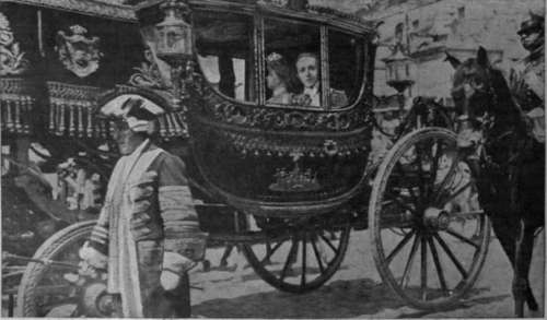 The King and Queen of Spain, in the gorgeous state coach drawn by eight cream coloured horses, returning to the Royal Palace,