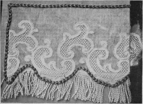 A fringed border on grass lawn, on which has been appliqued a white !ace pattern, will be rendered effective by a heading and edging of black and orange Russian braid