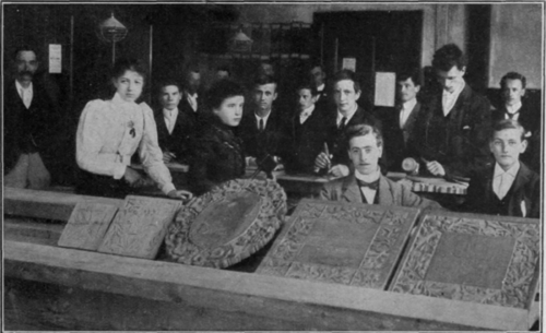 A wood carving class, and some of its work. In this department of handwork the women students are doing excellent work