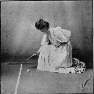 Fanning an egg across the barrier. This is the permissible method for girls in the egg contest