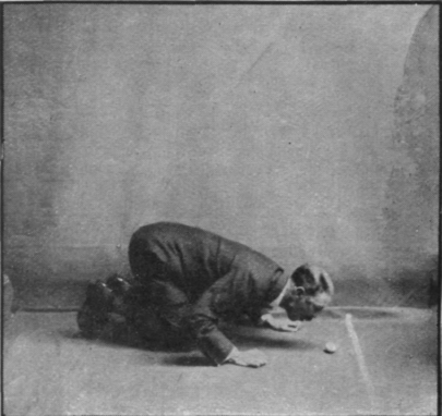 Man blowing an egg over the barrier into the enemy's territory in the Blow and fan the egg Contest, which should be played by a team of men who blow against a team of girls who fan the eggs