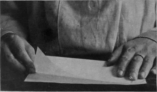 The first step in making paper lace folding the paper exactly in half