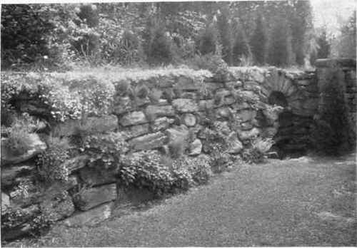 Fig. 172. A dry retaining wall with pockets for plants, where the water feature adds greatly to the scene. See page 226.