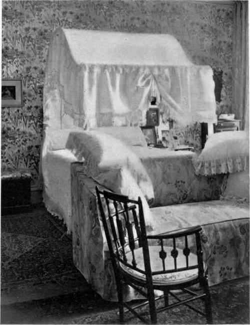 AT THE FOOT OF THE BED IS THE COUCH FACING THE FIRE