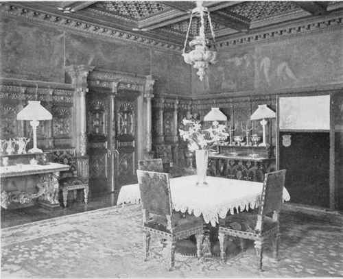 DINING ROOM IN NEW YORK HOME SHOWING CARVED WAINSCOTTING AND PAINTED FRIEZE