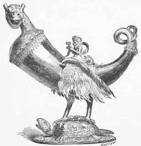 Hanap in the form of a chimaera, the body formed of a horn, mounted in silver gilt; the triton bears the Montfort arms German work of the Sixteenth Century. (Imperial Treasury, Vienna.)