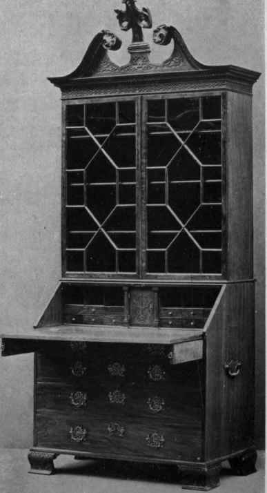 CHIPPENDALE BUREAU BOOKCASE WITH CHINESE BRACKET FEET, STRAIGHT TRA CERIED DOORS AND SWAN NECK PEDIMENT.