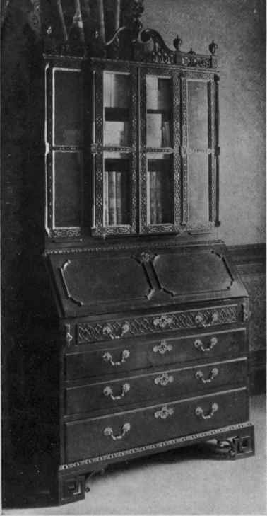 CHIPPENDALE BUREAU BOOKCASE WITH FRETTED BRACKET FEET AND FRETWORK ORNAMENT.
