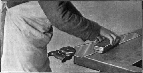 Fig. 72. Removing the Burr after Filing a Saw.