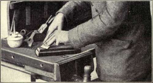 Fig. 51. Whetting or Oilstoning the Beveled Side of a Cutter.