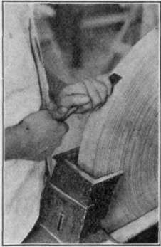 Fig. 85. Grinding a Chisel