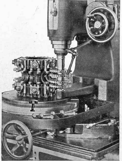 Fig. 342. Vertical Milling Machine in Action. Work Holding Fixture Rotates at Rate of 10 Inches per Minute; Production 195 Yokes per Hour