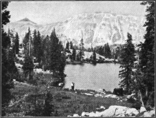 Snow Capped Peaks Tower Above The Glacial Lake