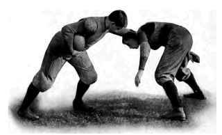 Showing the use of the stiff arm to avoid being tackled. The hand can be placed on head, shoulder, or often the body. The tackier can be thrown aside or side step ped.